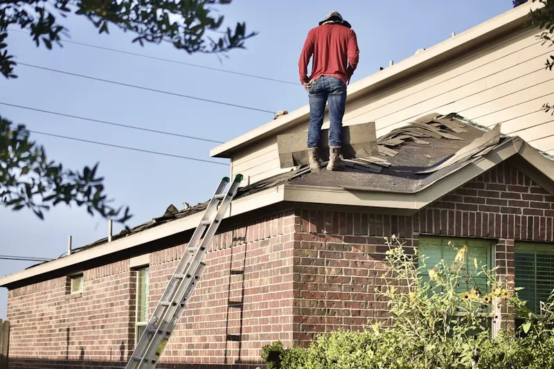 Professional roofer working on a residential roof in Statesboro
